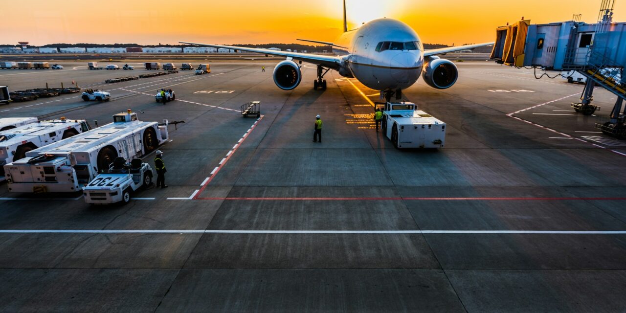 gray airplane on parking